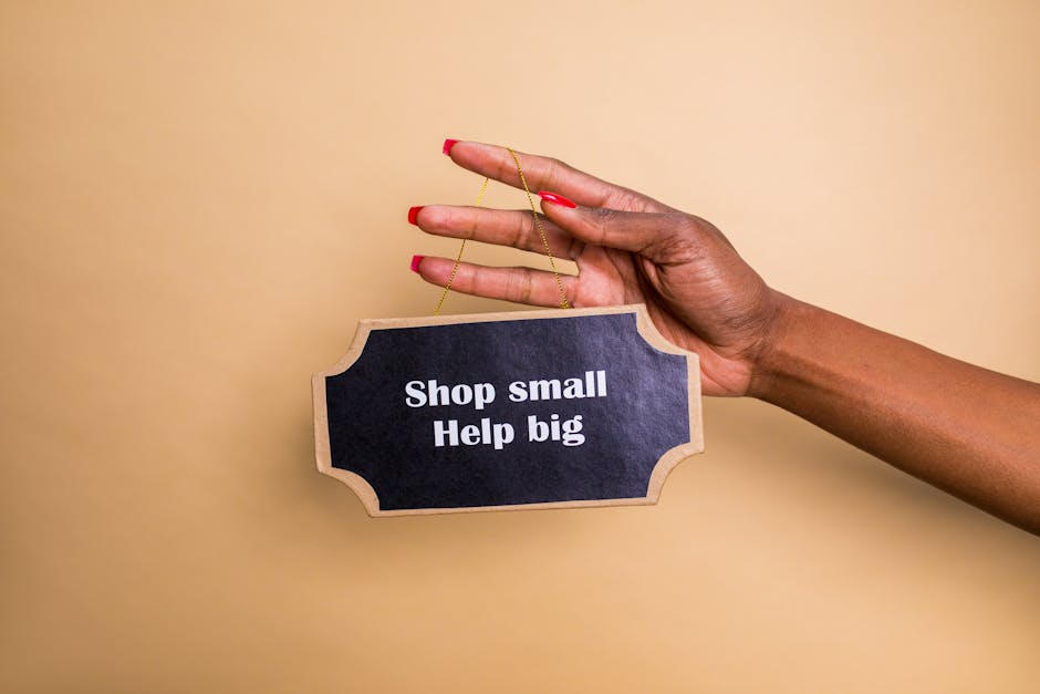 Close-up of a hand holding an inspiring sign encouraging small businesses support